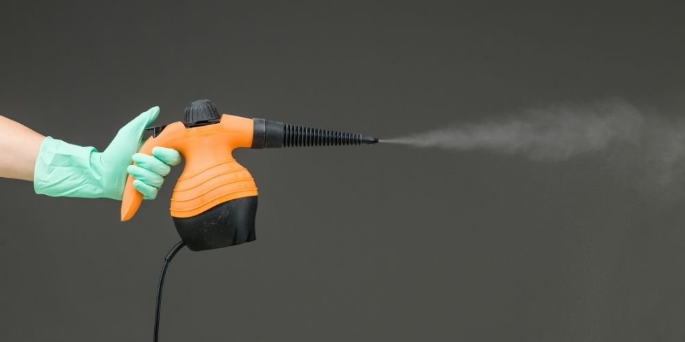 a woman using a steam cleaner
