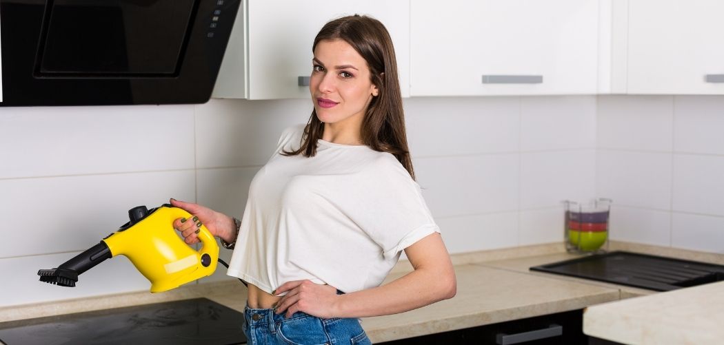 woman holding steam cleaner